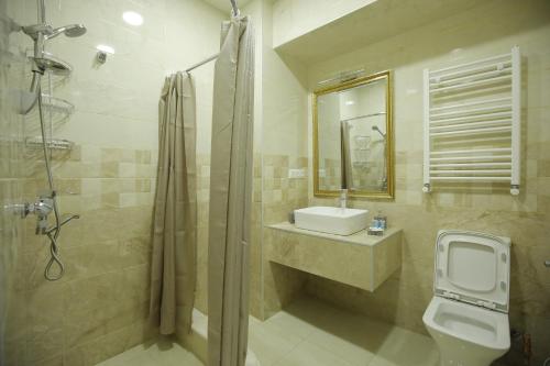 a bathroom with a sink and a toilet and a shower at HOTEL COMFORT in Kutaisi