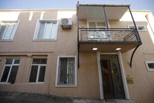 a building with a balcony and a door at HOTEL COMFORT in Kutaisi