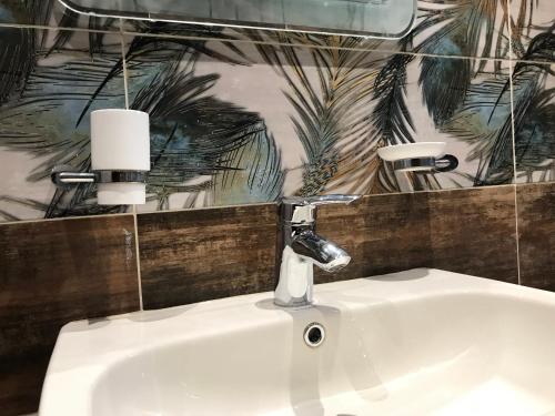a bathroom sink with a faucet on top of it at Cozy and Modern Apartment for Rent in Mohandessin in Cairo