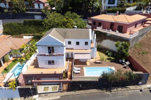 an aerial view of a house with a swimming pool at Home2Book Exclusive Villa with pool, El Sauzal in Sauzal