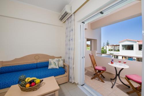 a living room with a bed and a table and a table at Toxo Hotel in Plataniás
