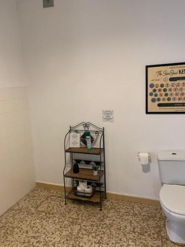 a bathroom with a toilet and a towel rack at Maria Magdalena - Room 4 in Málaga
