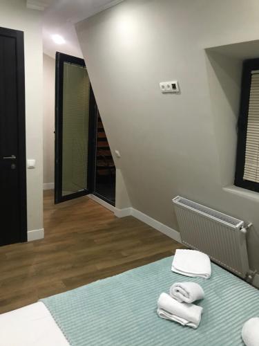 a room with a bed with two towels on it at D and D hotel in Tbilisi City