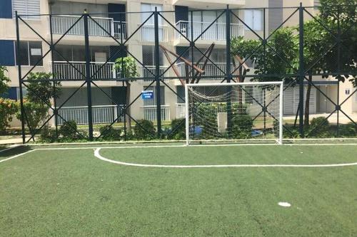a soccer field with a goal in front of a building at Lindo apartamento cerca a Girardot in Ricaurte