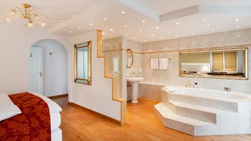 a large bathroom with a tub and a sink at Landgasthof Schwanen in Felben