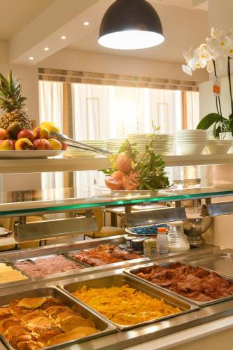 a buffet line with many different types of food at Hotel Delle Mimose in Lido di Jesolo