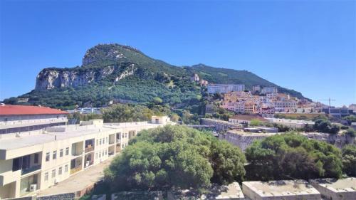 a view of a city with a mountain in the background at Swimming pools Apartment in Ocean Village - 2 bed 2 bath Rock view in Gibraltar