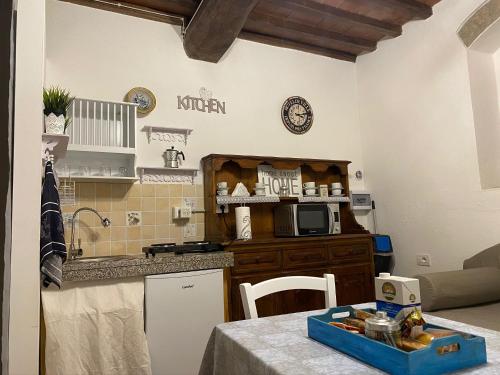 a kitchen with a table and a counter top at Podere Badia Valdrago Agriturismo Mugello Circuit in Scarperia