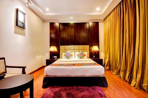 a bedroom with a king sized bed and a desk at Oriva Suvee Boutique Banashankari in Bengaluru