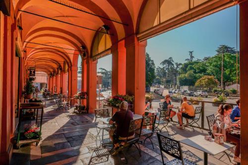 a group of people sitting at tables on a patio at A Casa Fachin Room & Breakfast in Bologna