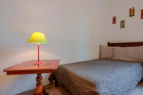a bedroom with a bed and a table with a lamp at A Casa Fachin Room & Breakfast in Bologna