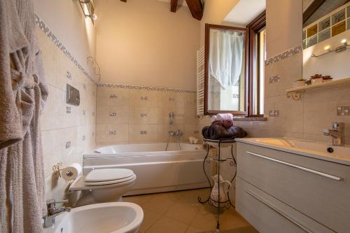a bathroom with a tub and a toilet and a sink at La Valle B&B in Asti
