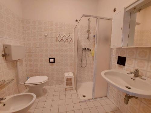 a bathroom with a shower and a toilet and a sink at Pagoda 4 in Lido di Pomposa
