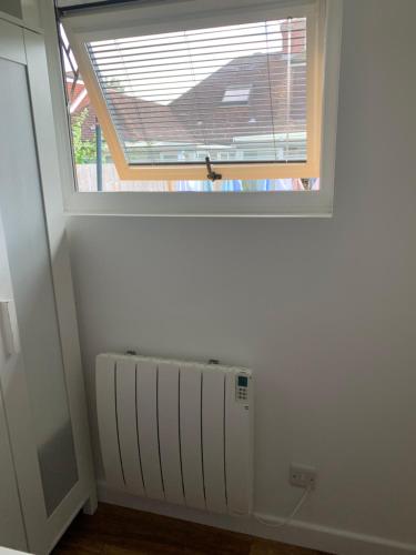a window in a room with a radiator under it at Lindas LODGE Free PARKING air con plus provisions included in Hove