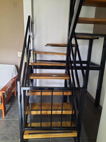 a set of wooden stairs in a room with a bed at El Remanso de Colón in Colón