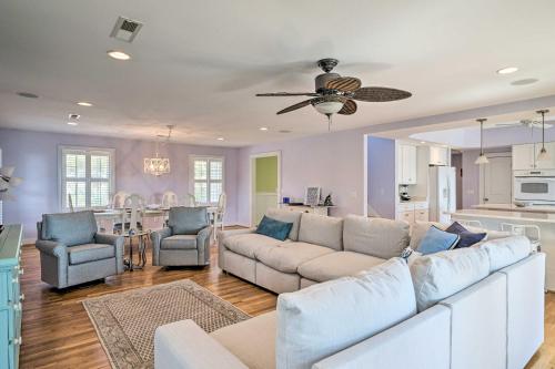 a living room with a white couch and a kitchen at Waterfront Hampstead Home Dock and Waterway Access! in Hampstead