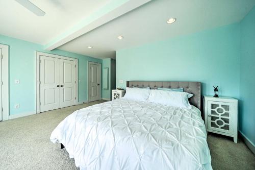 a bedroom with a large bed with blue walls at Waterfront Hampstead Home Dock and Waterway Access! in Hampstead