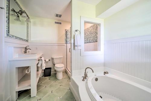 a bathroom with a tub and a toilet and a sink at Waterfront Hampstead Home Dock and Waterway Access! in Hampstead
