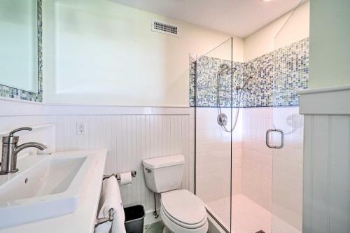 a bathroom with a toilet and a sink and a shower at Waterfront Hampstead Home Dock and Waterway Access! in Hampstead