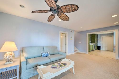 a living room with a blue couch and a ceiling fan at Waterfront Hampstead Home Dock and Waterway Access! in Hampstead