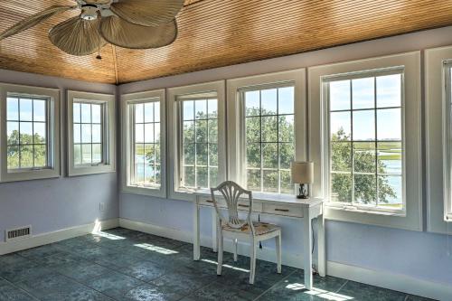a home office with a desk and windows at Waterfront Hampstead Home Dock and Waterway Access! in Hampstead