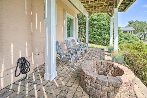 a patio with chairs and a fire pit on a house at Waterfront Hampstead Home Dock and Waterway Access! in Hampstead