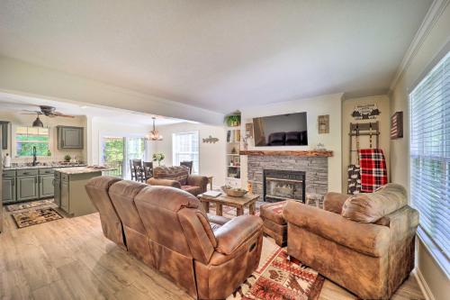 a living room with two couches and a fireplace at 9 Mi to Sugar Mountain Newland Cabin with Fire Pit! in Newland