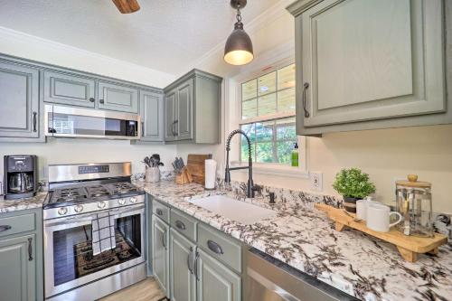 a kitchen with blue cabinets and a sink and a counter at 9 Mi to Sugar Mountain Newland Cabin with Fire Pit! in Newland