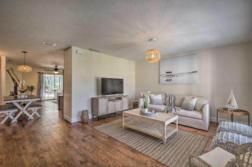 a living room with a couch and a tv at Naples Oasis with Screened Pool, Bike to Beach! in Naples