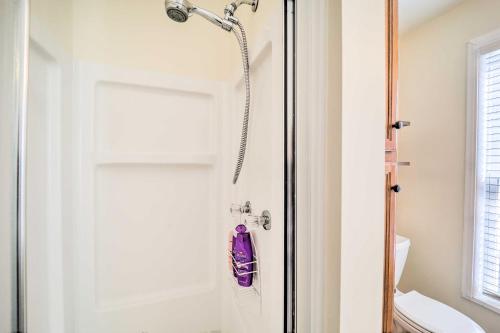 a shower in a bathroom next to a toilet at 9 Mi to Sugar Mountain Newland Cabin with Fire Pit! in Newland