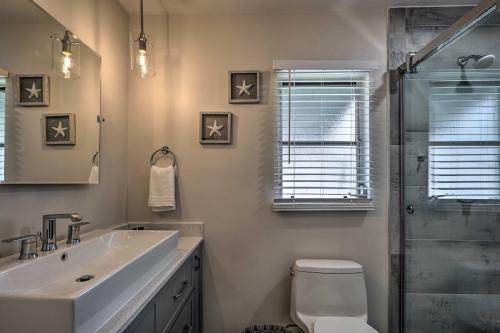 a bathroom with a sink and a toilet and a shower at Naples Oasis with Screened Pool, Bike to Beach! in Naples