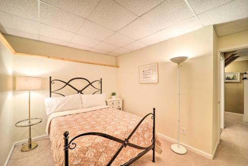 a bedroom with a bed and a lamp in it at 9 Mi to Sugar Mountain Newland Cabin with Fire Pit! in Newland