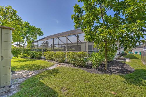 a large glass building with trees in front of it at Naples Oasis with Screened Pool, Bike to Beach! in Naples
