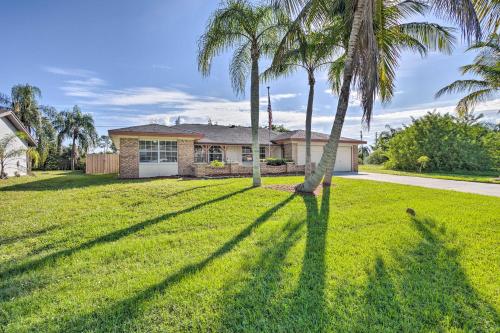 a yard with palm trees in front of a house at Modern Port St Lucie Home with Private Outdoor Oasis in River Park
