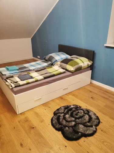 a bed in a bedroom with a rug on the floor at Ferienhaus mit Kamin in Krackow