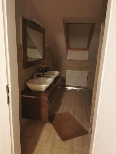 a bathroom with two sinks and a mirror at Ferienhaus mit Kamin in Krackow