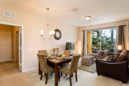 a dining room and living room with a table and chairs at Spacious 2BR 2BA with Balcony 5 Mins to Convention Center & Epic Universe in Orlando