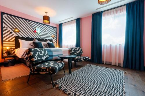 a bedroom with a bed and a table and chairs at Selina Camden in London