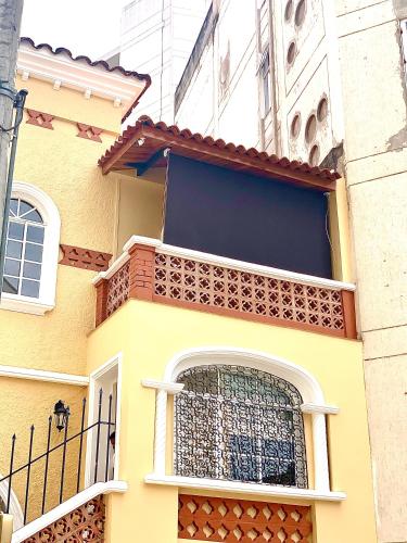 a yellow building with a window with a fence at Casa Rambla Serra Cali in Cali