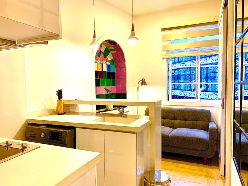 a kitchen with a sink and a living room at Casa Rambla Serra Cali in Cali