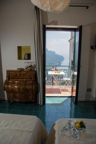 a room with two beds and a sliding glass door at La Moresca in Ravello