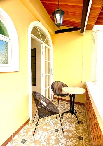 a patio with a table and chairs on a porch at Casa Rambla Serra Cali in Cali
