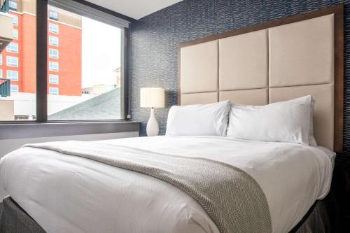 a bedroom with a large bed with a large window at Haywood Park Hotel, an Ascend Collection Hotel in Asheville