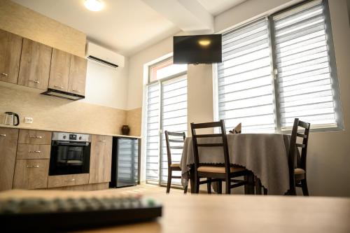 a kitchen and dining room with a table and chairs at Апартаменти ЗДРАВЕ in Sapareva Banya