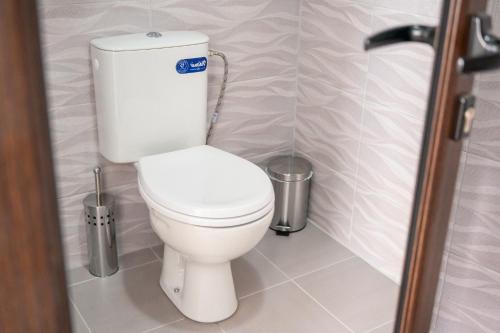 a bathroom with a white toilet in a stall at Апартаменти ЗДРАВЕ in Sapareva Banya