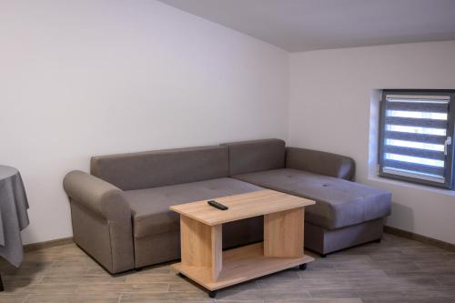 a living room with a couch and a coffee table at Апартаменти ЗДРАВЕ in Sapareva Banya
