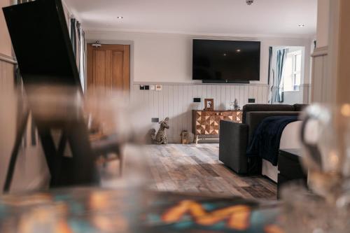 a living room with a couch and a tv at South Causey Inn in Stanley