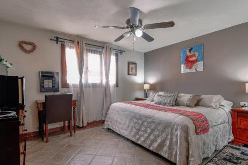 a bedroom with a bed and a ceiling fan at Casa Maricela B&B in San Miguel de Allende