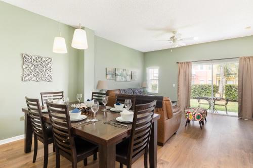 a dining room and living room with a table and chairs at Family Getaway Townhome at Lake Berkley 15min to Disney in Kissimmee