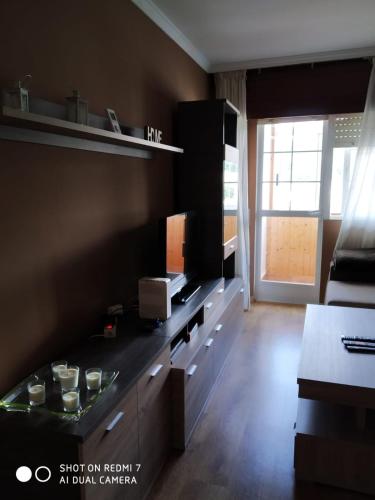 a living room with a kitchen with a counter top at Gonsa 1 in Padrón
